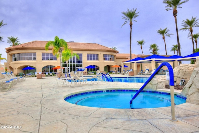 pool with a community hot tub and a patio area