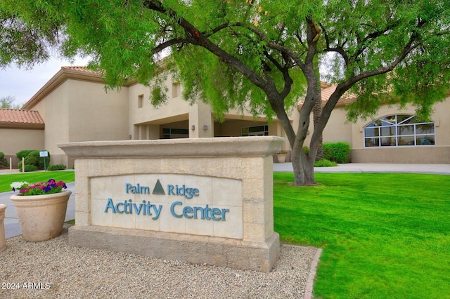 community sign featuring a lawn