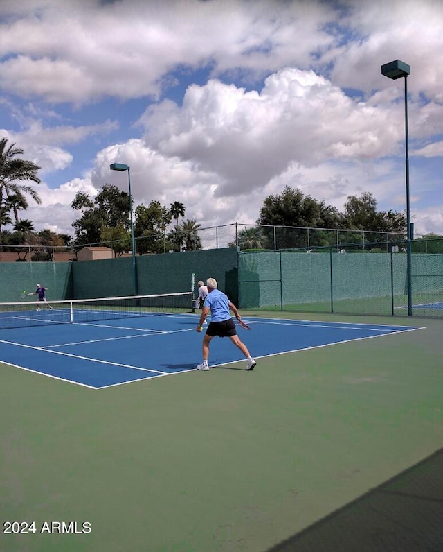 view of sport court with fence