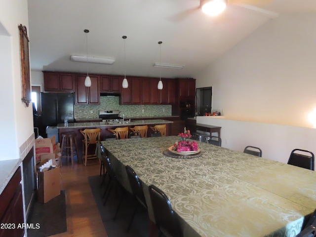 639 W US Highway 60, Superior, AZ 85173 - dining room with ceiling fan, sink, dark hardwood / wood-style floors, and vaulted ceiling