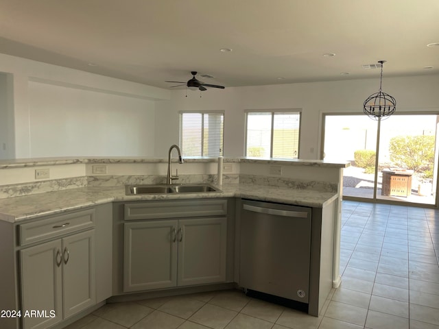 kitchen featuring light tile patterned floors, sink, stainless steel dishwasher, and decorative light fixtures