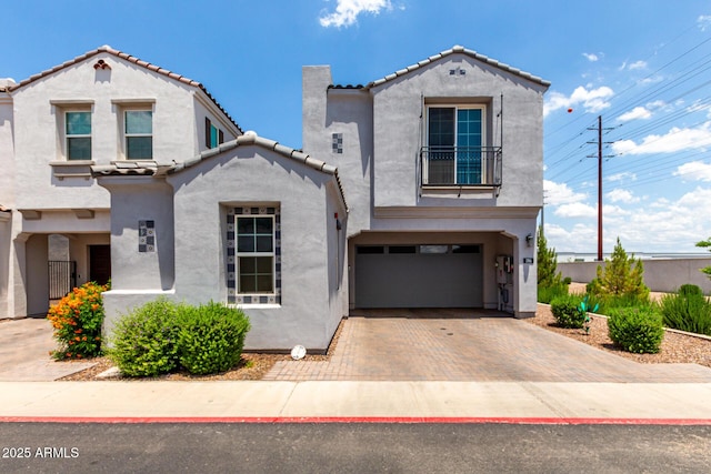286 E Raleigh Dr, Chandler, AZ 85286 - view of front of home with an attached garage, a tile roof, stucco siding, decorative driveway, and a balcony