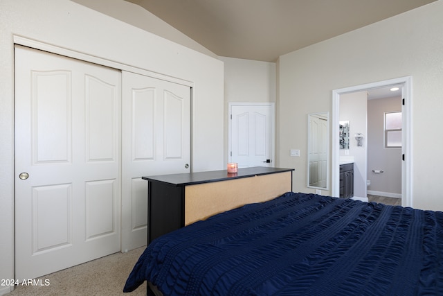 bedroom with lofted ceiling, connected bathroom, carpet, and a closet