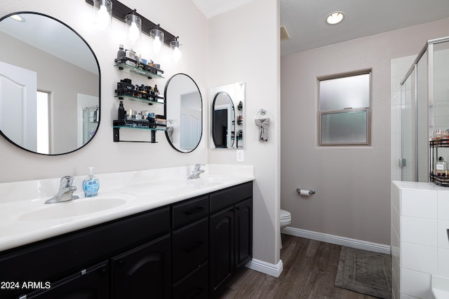 bathroom with vanity, hardwood / wood-style floors, toilet, and walk in shower