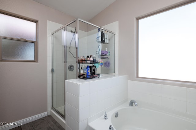 bathroom with separate shower and tub