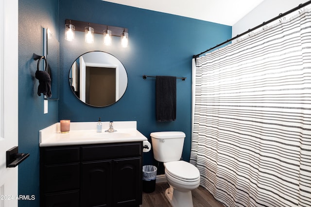 bathroom featuring lofted ceiling, vanity, hardwood / wood-style floors, and toilet