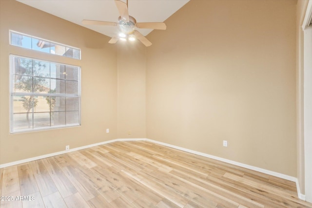 empty room with baseboards, light wood-type flooring, and ceiling fan