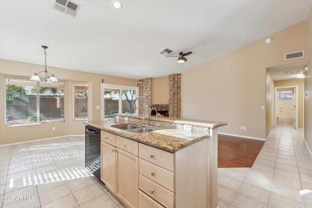 kitchen with visible vents, light brown cabinets, a sink, black dishwasher, and light tile patterned flooring