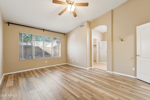 unfurnished room featuring visible vents, arched walkways, a ceiling fan, and light wood finished floors