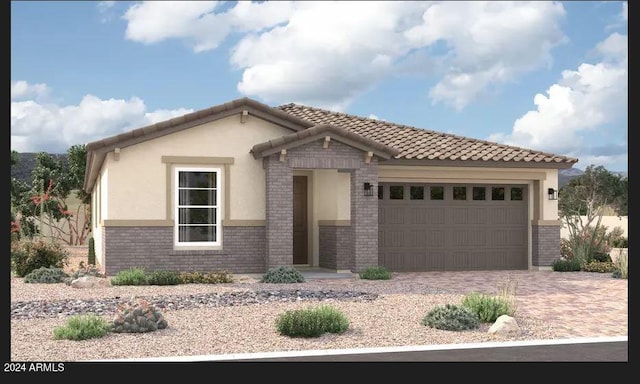 mediterranean / spanish house with brick siding, a tiled roof, an attached garage, decorative driveway, and stucco siding