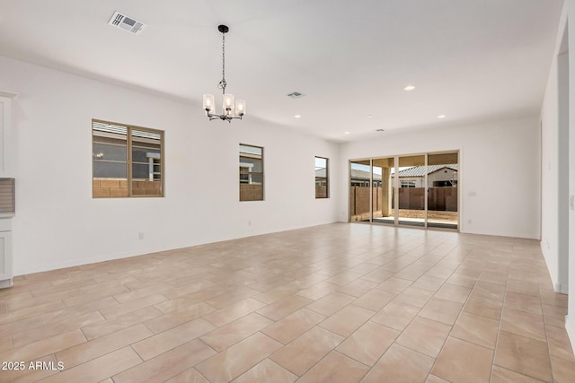 empty room with baseboards, visible vents, an inviting chandelier, and recessed lighting