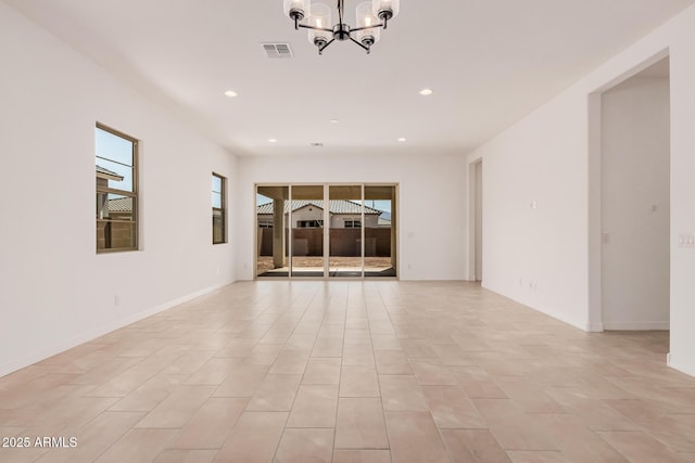 spare room featuring recessed lighting, a notable chandelier, baseboards, and visible vents