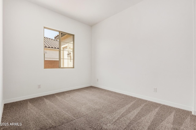 unfurnished room featuring baseboards and carpet floors