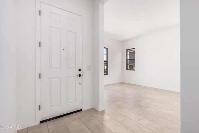 entryway featuring baseboards
