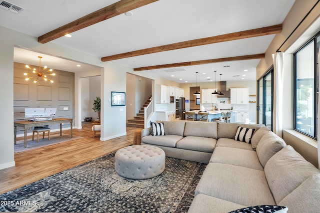 826 E Buist Ave, Phoenix, AZ 85042 - living area featuring a chandelier, light wood-style flooring, beamed ceiling, baseboards, and recessed lighting