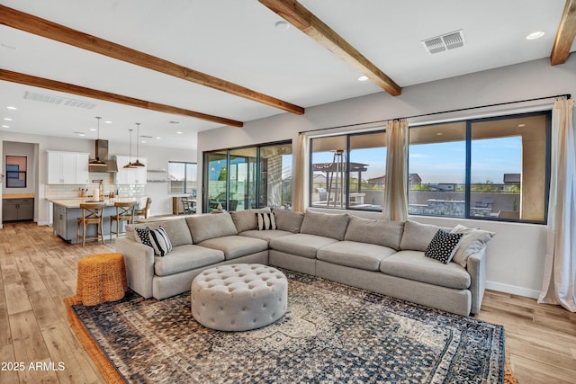 826 E Buist Ave, Phoenix, AZ 85042 - living room with beamed ceiling, light wood-style floors, and recessed lighting