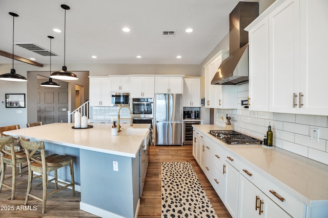 826 E Buist Ave, Phoenix, AZ 85042 - kitchen featuring stainless steel appliances, dark wood-style floors, backsplash, white cabinets, and recessed lighting
