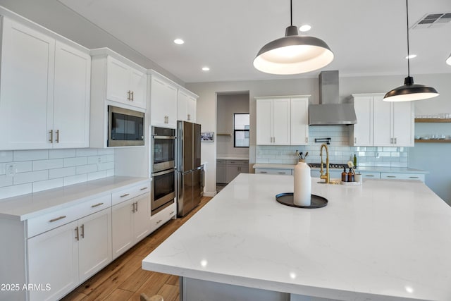 826 E Buist Ave, Phoenix, AZ 85042 - kitchen featuring wall chimney exhaust hood, built in microwave, stainless steel double oven, backsplash, and recessed lighting