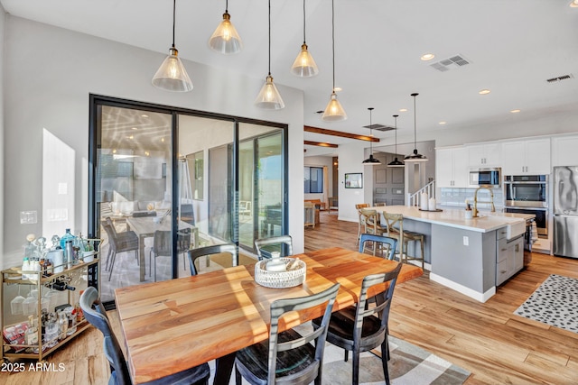 826 E Buist Ave, Phoenix, AZ 85042 - dining space featuring light wood-style flooring, recessed lighting, and baseboards