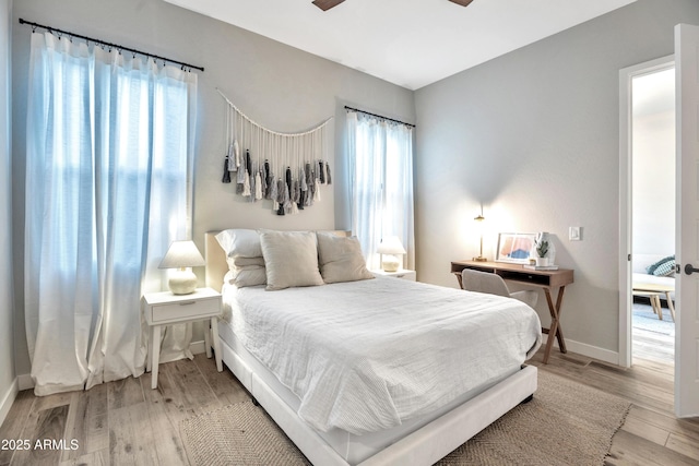 826 E Buist Ave, Phoenix, AZ 85042 - bedroom featuring light wood-style floors and baseboards