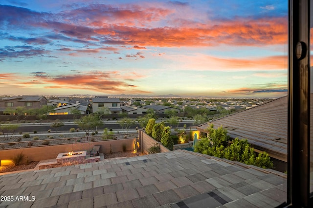 826 E Buist Ave, Phoenix, AZ 85042 - patio terrace at dusk with an outdoor fire pit, a residential view, and fence
