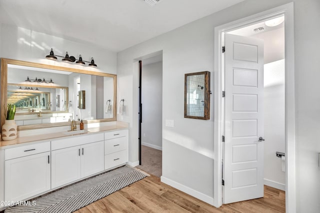 826 E Buist Ave, Phoenix, AZ 85042 - bathroom with wood finished floors, vanity, and baseboards