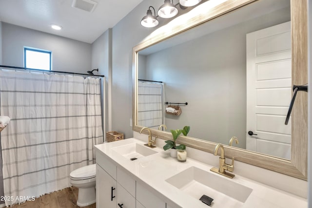 826 E Buist Ave, Phoenix, AZ 85042 - full bath featuring toilet, wood finished floors, double vanity, and a shower with shower curtain