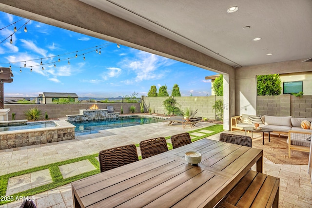 826 E Buist Ave, Phoenix, AZ 85042 - view of patio with a fenced backyard, outdoor dining space, an outdoor hangout area, and a pool with connected hot tub