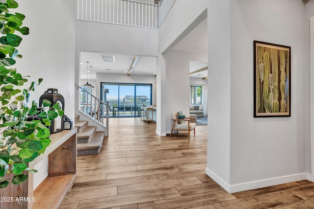 826 E Buist Ave, Phoenix, AZ 85042 - foyer featuring a high ceiling, stairway, baseboards, and wood finished floors