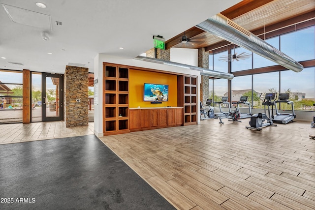 826 E Buist Ave, Phoenix, AZ 85042 - gym featuring expansive windows, healthy amount of natural light, french doors, ceiling fan, and wood finished floors