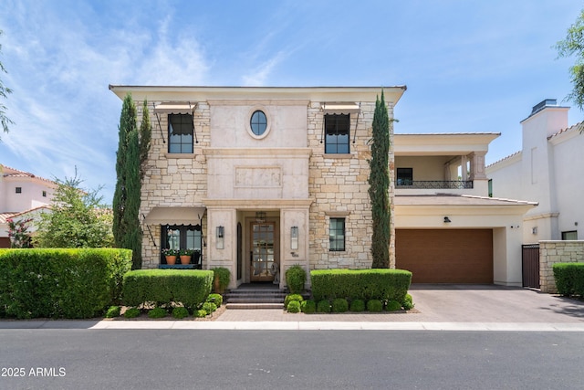 3511 N 39th Pl, Phoenix, AZ 85018 - view of front of property with stone siding, a garage, a balcony, and driveway