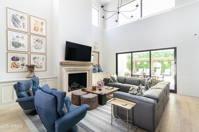 3511 N 39th Pl, Phoenix, AZ 85018 - living room with a towering ceiling, hardwood / wood-style flooring, a fireplace, and plenty of natural light