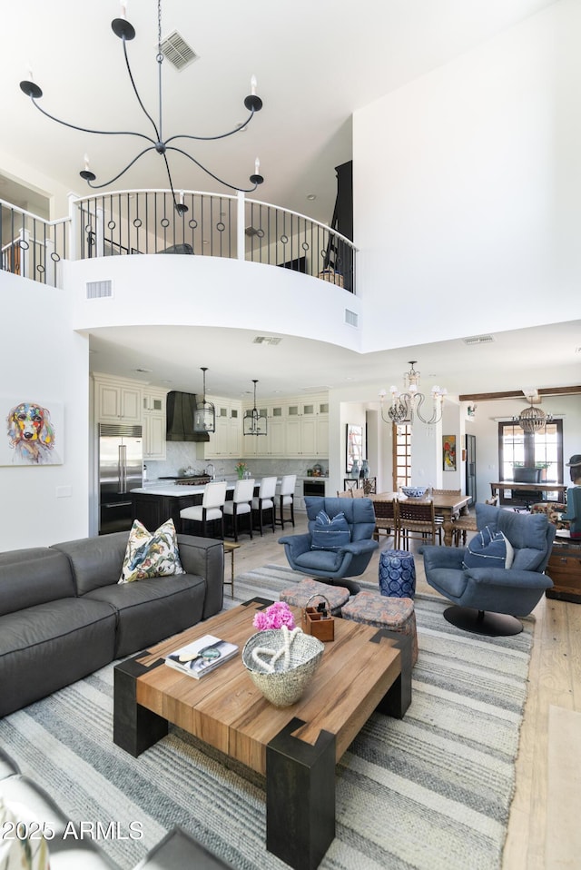 3511 N 39th Pl, Phoenix, AZ 85018 - living area featuring a chandelier, wood finished floors, and a high ceiling