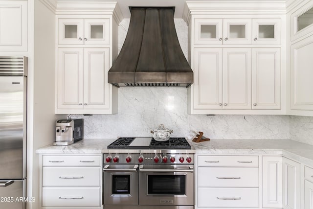 3511 N 39th Pl, Phoenix, AZ 85018 - kitchen featuring premium range hood, high end appliances, decorative backsplash, and glass insert cabinets