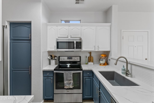 470 N 168th Ln, Goodyear, AZ 85338 - kitchen featuring visible vents, blue cabinetry, stainless steel appliances, white cabinetry, and a sink