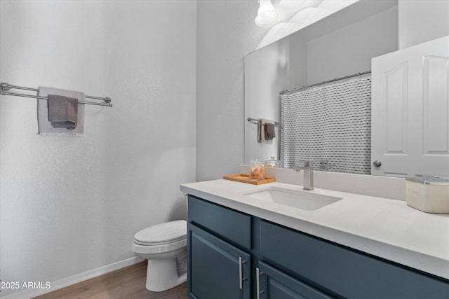 470 N 168th Ln, Goodyear, AZ 85338 - bathroom featuring baseboards, toilet, a shower with curtain, wood finished floors, and vanity