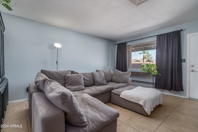 tiled living room with a baseboard heating unit