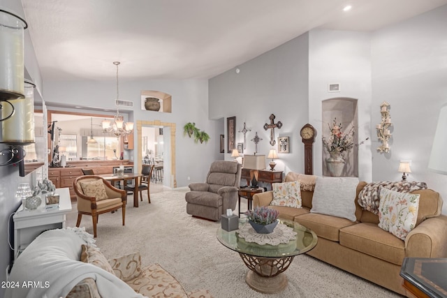 living room featuring carpet flooring, lofted ceiling, and a notable chandelier