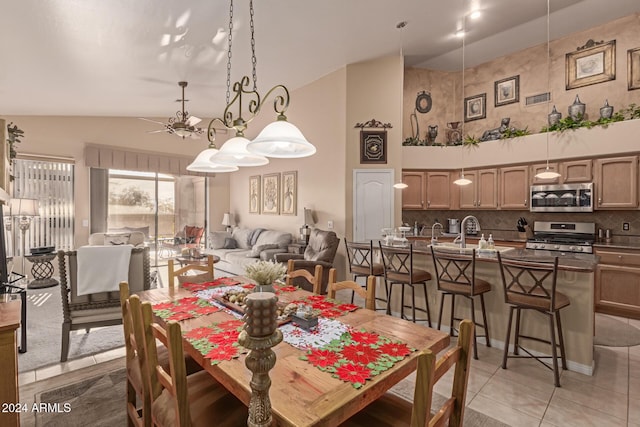 dining space with high vaulted ceiling and tile patterned floors