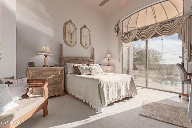 bedroom with ceiling fan, access to exterior, carpet flooring, and vaulted ceiling