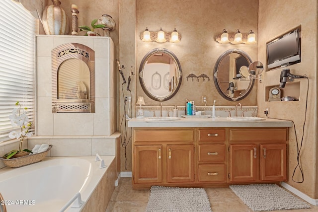 bathroom featuring vanity, tile patterned floors, and a relaxing tiled tub