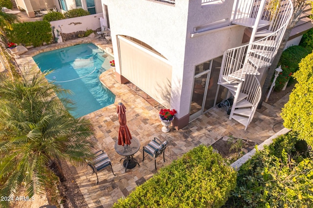 view of swimming pool with a patio