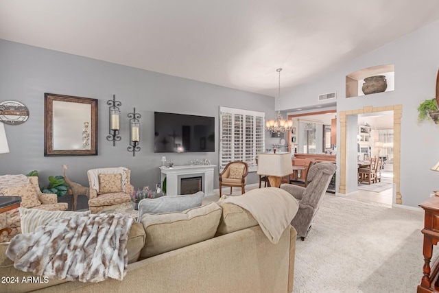 living room with light carpet, lofted ceiling, and a notable chandelier