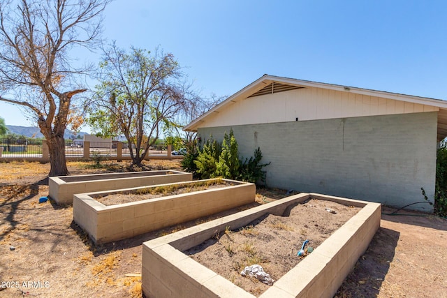 view of yard with a vegetable garden and fence