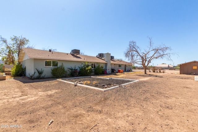 back of property featuring central air condition unit