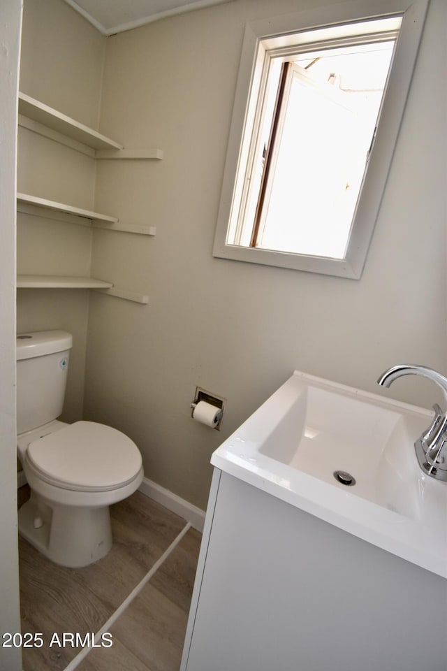 543 W Sunset Ave, Coolidge, AZ 85128 - half bathroom featuring vanity, baseboards, and toilet