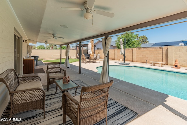 view of pool with ceiling fan, a fenced backyard, and a patio area