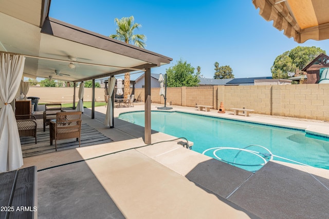 view of pool featuring a patio, a fenced backyard, and a ceiling fan