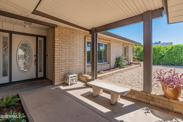 doorway to property with brick siding