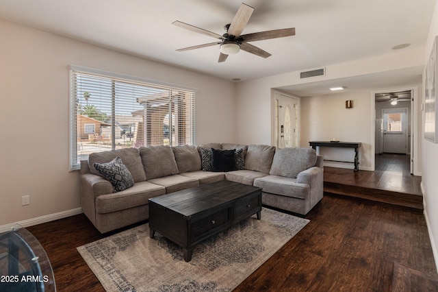 living area featuring ceiling fan, healthy amount of natural light, wood finished floors, and baseboards